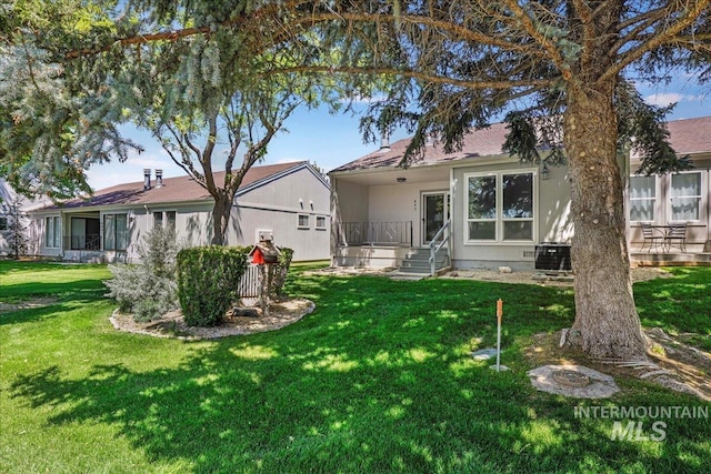 300 Morrison Unit 643, Twin Falls, ID 83301 - rear view of property featuring a lawn and central AC