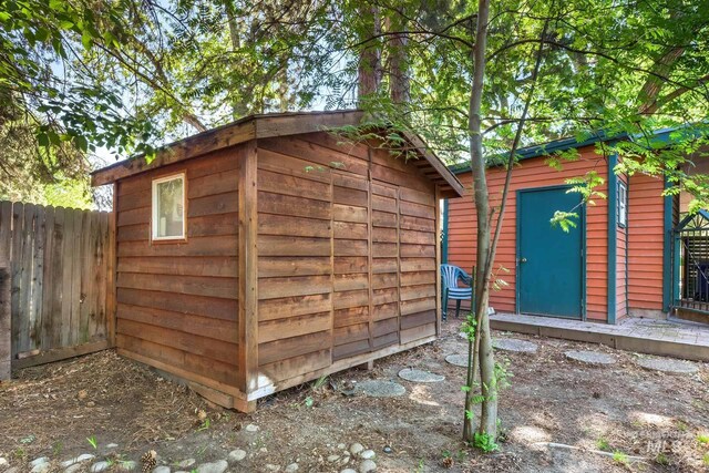 view of shed featuring fence