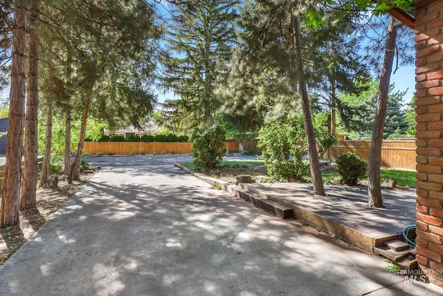 view of home's community with fence and a patio