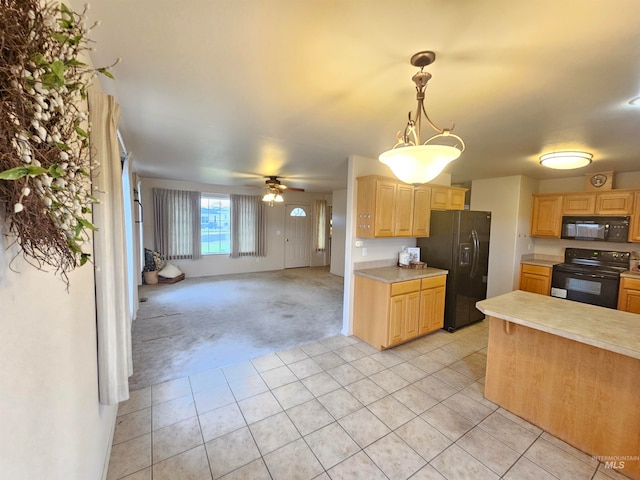 kitchen with ceiling fan, black appliances, light brown cabinets, light tile patterned floors, and hanging light fixtures