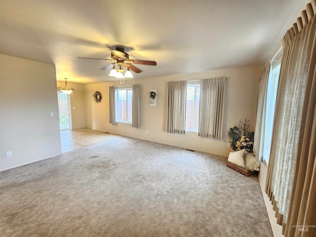 carpeted spare room with a textured ceiling and ceiling fan