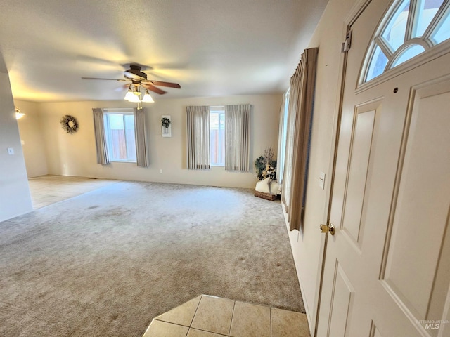 carpeted empty room with ceiling fan