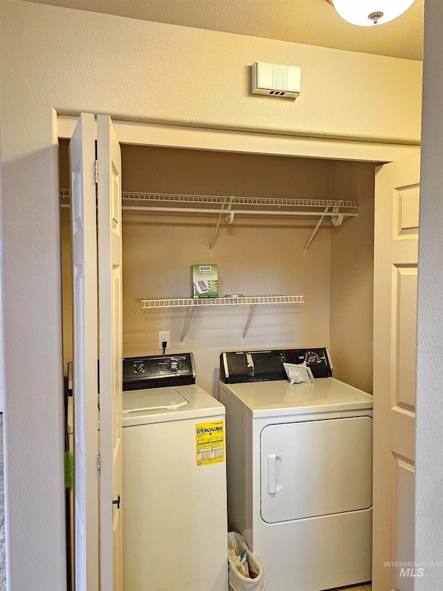 clothes washing area featuring washing machine and clothes dryer