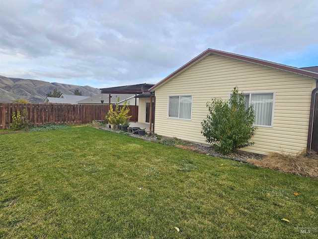 exterior space with a lawn and a mountain view