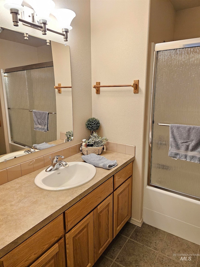 bathroom featuring vanity, tile patterned floors, and bath / shower combo with glass door