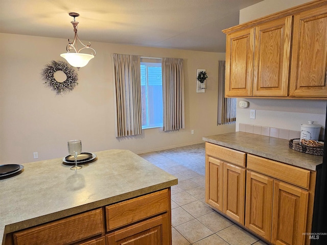 kitchen with light tile patterned floors and pendant lighting