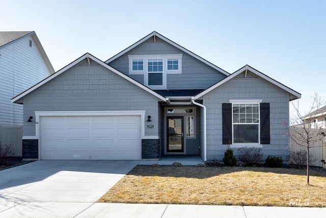 view of front of home with a garage, concrete driveway, and a front lawn