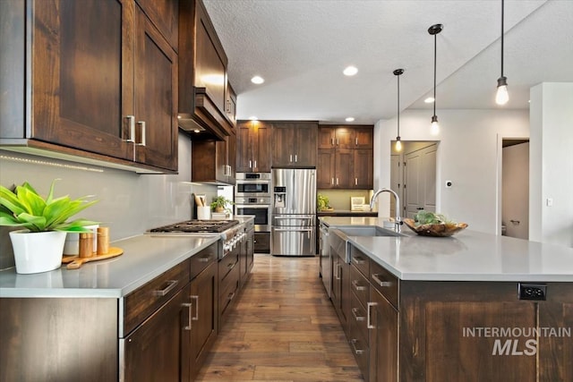 5085 S Taboo Pl, Boise, ID 83716 - kitchen with stainless steel appliances, dark wood-type flooring, light countertops, dark brown cabinetry, and recessed lighting