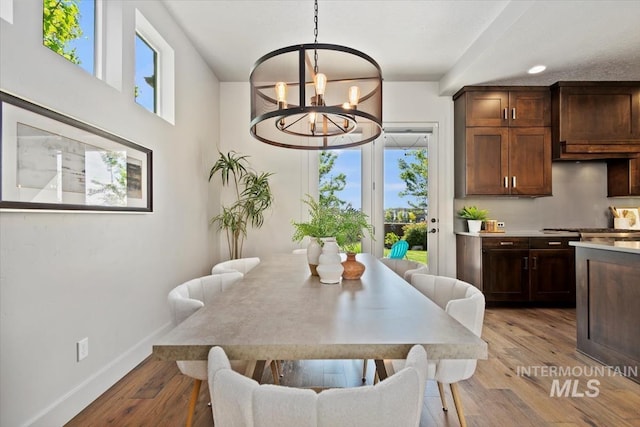 5085 S Taboo Pl, Boise, ID 83716 - dining space featuring a chandelier, light wood-style floors, and baseboards