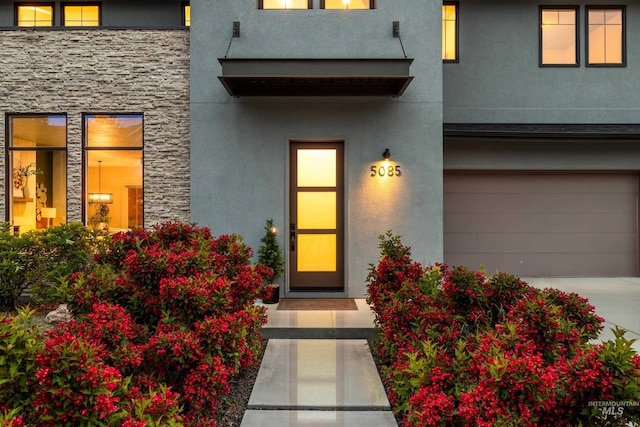 5085 S Taboo Pl, Boise, ID 83716 - entrance to property featuring stucco siding, stone siding, a garage, and driveway