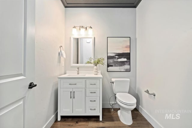 5085 S Taboo Pl, Boise, ID 83716 - bathroom featuring toilet, wood finished floors, vanity, and baseboards