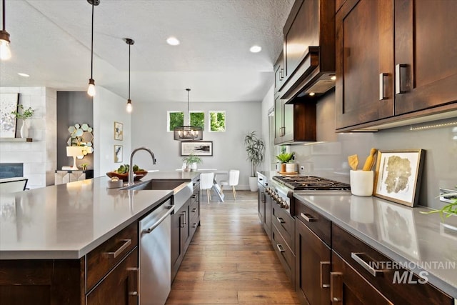 5085 S Taboo Pl, Boise, ID 83716 - kitchen with appliances with stainless steel finishes, a sink, hardwood / wood-style flooring, light countertops, and a textured ceiling