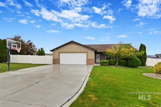 view of front of house with a garage, brick siding, fence, a front lawn, and stucco siding