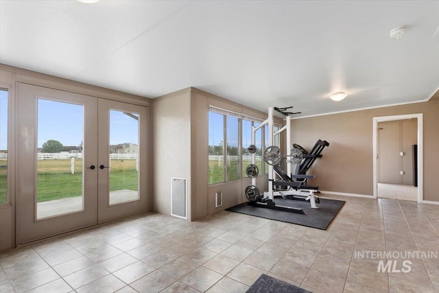 workout room with french doors, light tile patterned flooring, and baseboards