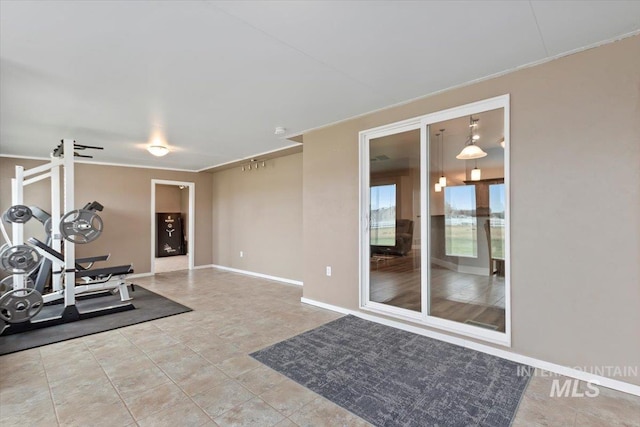 workout area featuring tile patterned flooring and baseboards