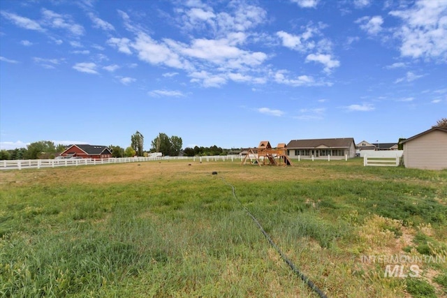 view of yard with a rural view and fence