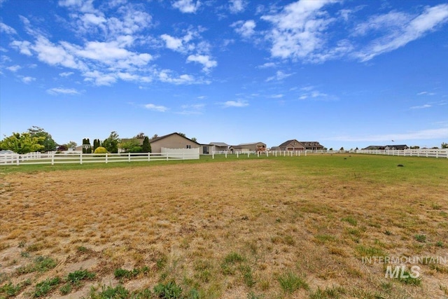 view of yard featuring a rural view and fence