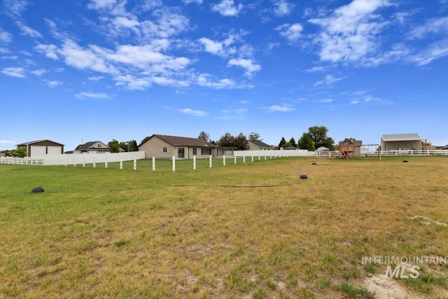 view of yard with a rural view and fence