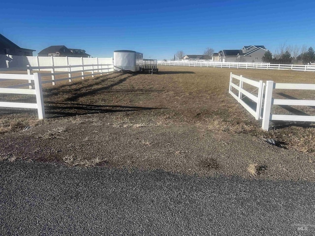 view of yard with a rural view and fence