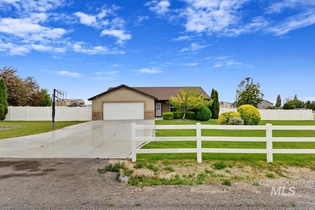 view of front facade featuring a fenced front yard, a front lawn, driveway, and an attached garage