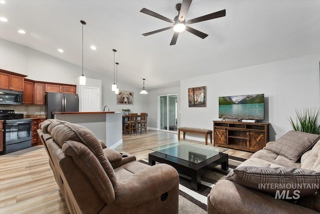 living area with recessed lighting, a ceiling fan, high vaulted ceiling, light wood-type flooring, and baseboards