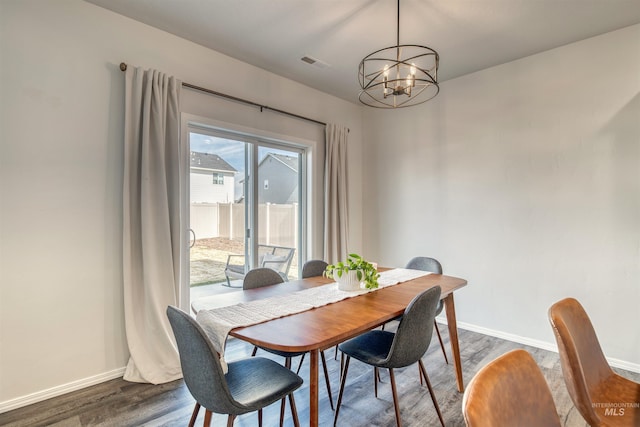 dining space featuring dark wood finished floors, visible vents, and baseboards