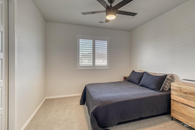 carpeted bedroom featuring visible vents, baseboards, and a ceiling fan