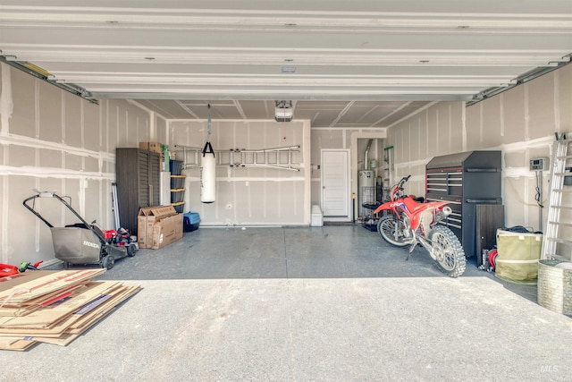 garage featuring a garage door opener and water heater