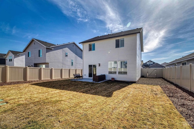 back of property with a yard, a patio, and a fenced backyard