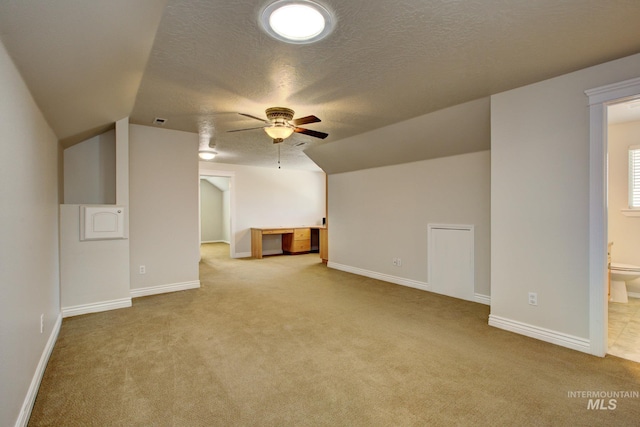 2853 N High Desert Way, Meridian, ID 83646 - additional living space featuring carpet flooring, a ceiling fan, a textured ceiling, lofted ceiling, and baseboards