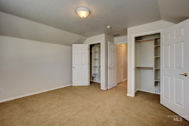 2853 N High Desert Way, Meridian, ID 83646 - unfurnished bedroom featuring light carpet, vaulted ceiling, baseboards, a textured ceiling, and multiple closets