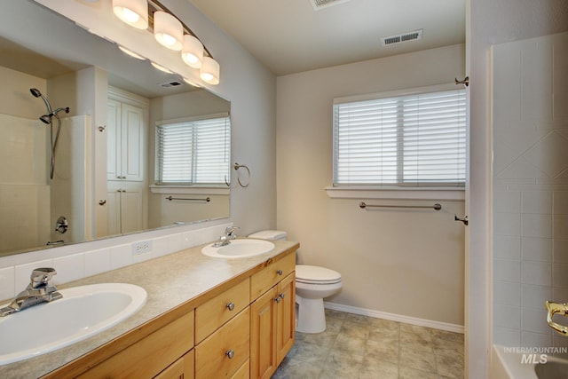 2853 N High Desert Way, Meridian, ID 83646 - bathroom with toilet, baseboards, double vanity, and tub / shower combination