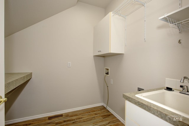 2853 N High Desert Way, Meridian, ID 83646 - laundry room featuring cabinet space, washer hookup, light wood-style flooring, and baseboards