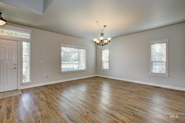 2853 N High Desert Way, Meridian, ID 83646 - entryway with a chandelier, wood finished floors, and baseboards