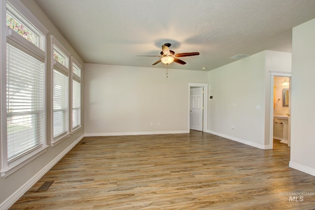2853 N High Desert Way, Meridian, ID 83646 - empty room featuring plenty of natural light, a ceiling fan, light wood-style floors, and baseboards