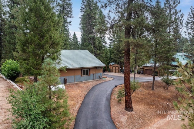 view of front of home featuring a storage unit