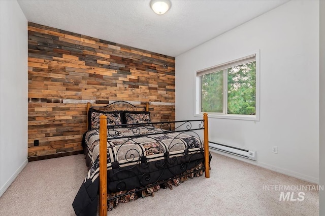 carpeted bedroom featuring wooden walls, a textured ceiling, and baseboard heating