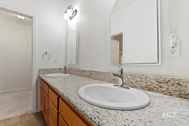 bathroom featuring tile patterned flooring and vanity