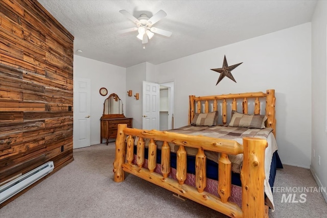 carpeted bedroom with a textured ceiling, a baseboard radiator, and ceiling fan