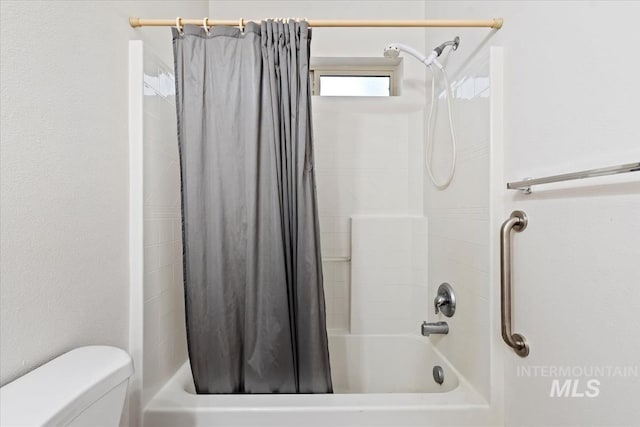 bathroom featuring toilet and shower / bathtub combination with curtain