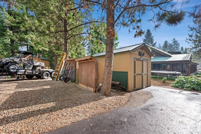 view of side of home with a storage unit