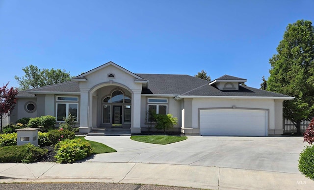 ranch-style house featuring concrete driveway, a garage, a shingled roof, and stucco siding