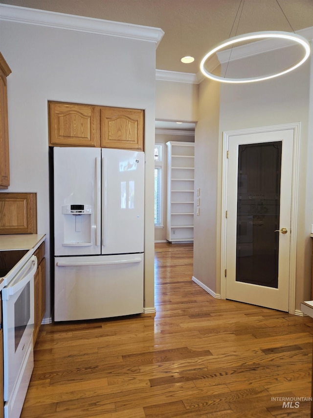 1203 Tara Ct, Fruitland, ID 83619 - kitchen with light wood finished floors, white appliances, recessed lighting, baseboards, and ornamental molding