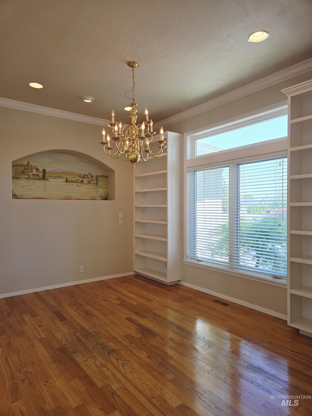 1203 Tara Ct, Fruitland, ID 83619 - spare room featuring ornamental molding, wood finished floors, and a chandelier