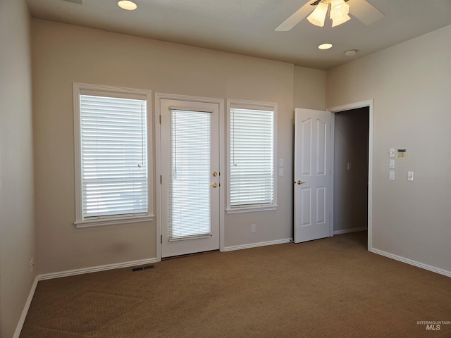 1203 Tara Ct, Fruitland, ID 83619 - doorway to outside with baseboards, ceiling fan, and carpet