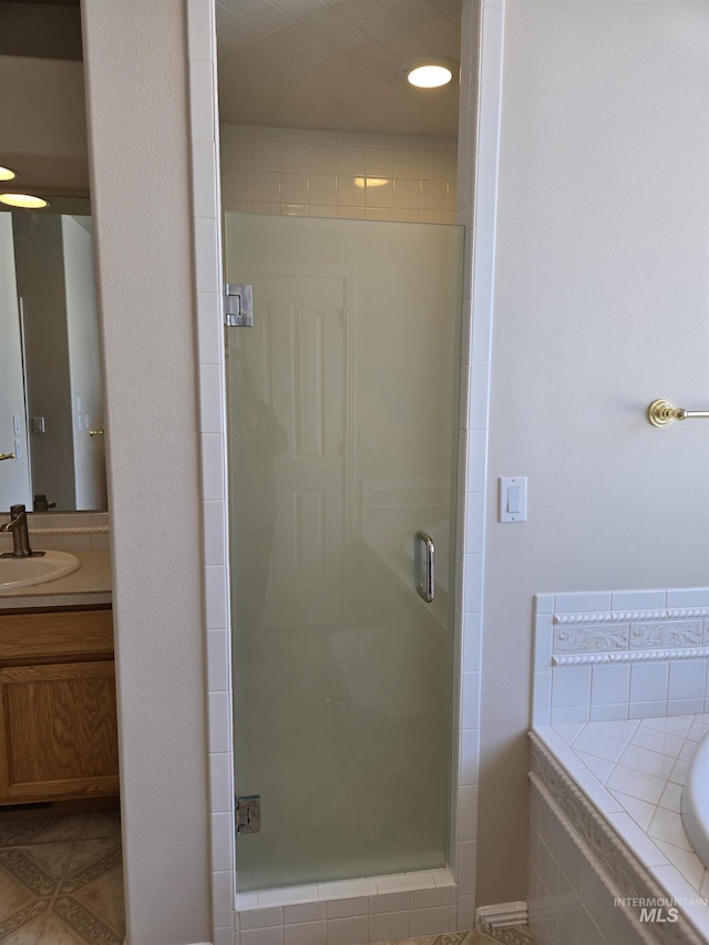 1203 Tara Ct, Fruitland, ID 83619 - full bathroom featuring vanity, a bath, and a stall shower