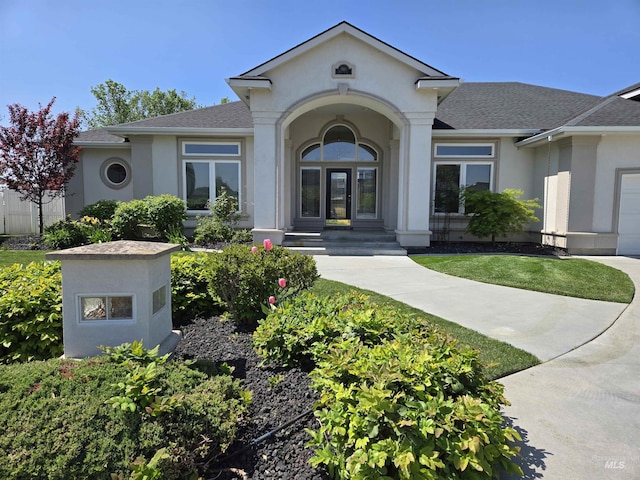 1203 Tara Ct, Fruitland, ID 83619 - doorway to property featuring roof with shingles and stucco siding