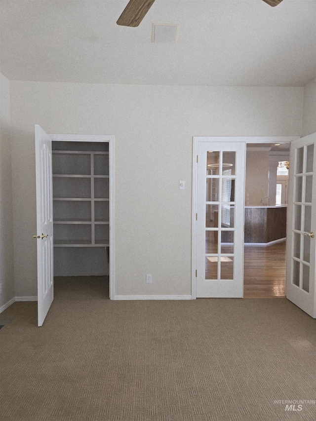 1203 Tara Ct, Fruitland, ID 83619 - carpeted empty room featuring french doors, a ceiling fan, and baseboards