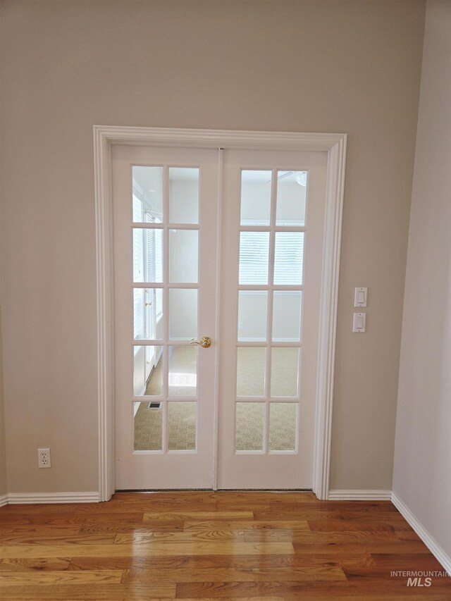 1203 Tara Ct, Fruitland, ID 83619 - entryway with french doors, baseboards, and light wood-style flooring