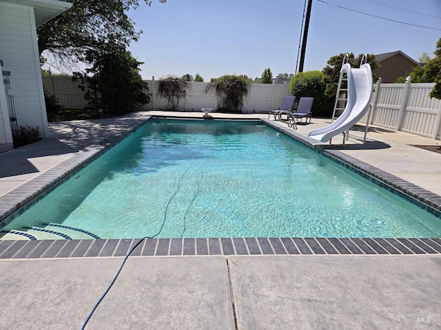 1203 Tara Ct, Fruitland, ID 83619 - view of pool with a fenced in pool, a fenced backyard, a patio area, and a water slide